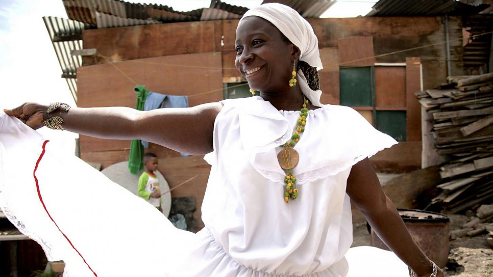 Maribeth dances outside her house in Soacha, Colombia. "My spirit is free when I dance and I am in another world".