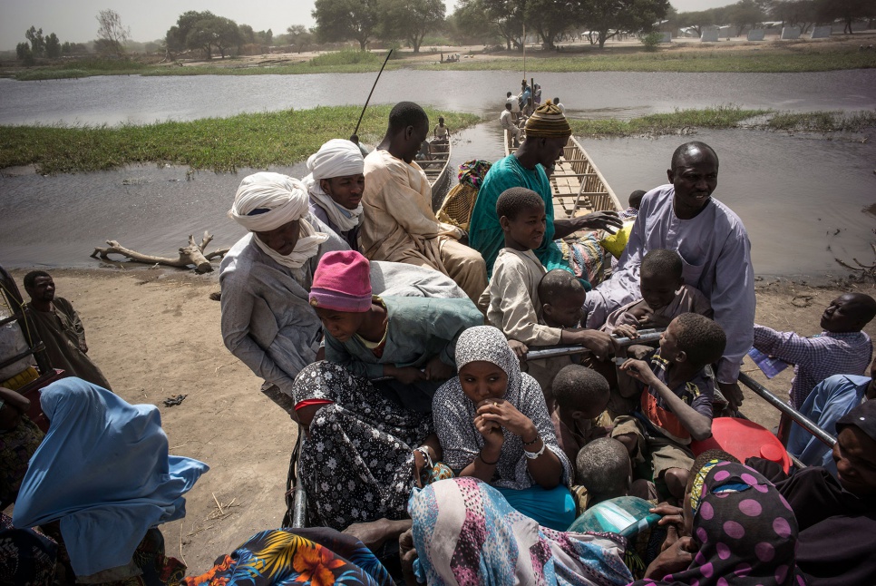 Nigerian refugees leave Ngouboua, on the shores of Lake Chad, on 11 February 2015. They are heading for a safer place, away from the border.