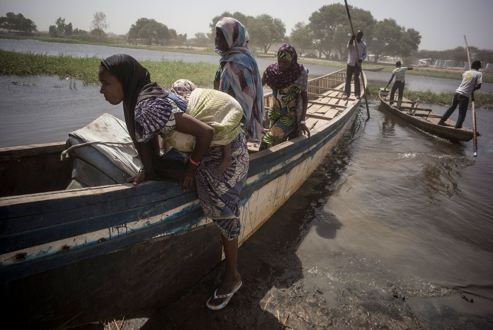 Nigerian refugees disembark from a canoe that carried them from Ngouboua to Baga Sola, Chad. Two days later an attack on Ngouboua killed 10 people.