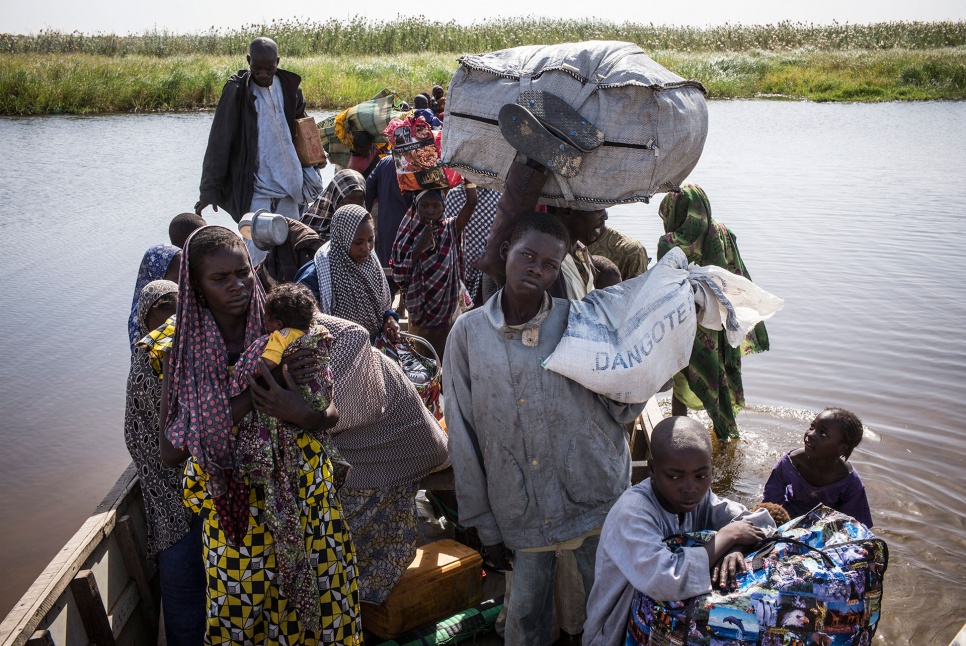 Five weeks after an attack on his village in Nigeria, Alhaji Haoudou (centre), 16, arrives in Baga Sola, Chad. Beside him is his aunt, Kalthouma Abakar, 22, and her newborn daughter.