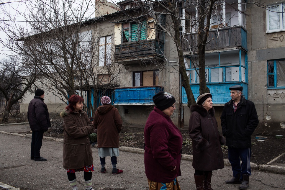 Residents enjoy the fresh air outside their apartment block in the Kievsky district of Donetsk, Ukraine. They spend long periods in the basement hiding from shelling.