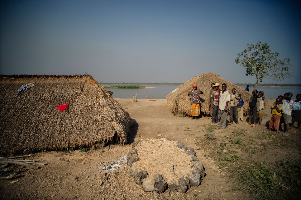 A child's grave sits amid recently constructed shelters in Gbadakila spontaneous refugee site on the banks of the Oubangui River, which separates CAR and DRC.