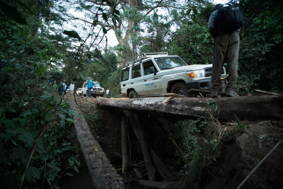 A UNHCR vehicle breaks through the surface planking and becomes stuck on a dangerous bridge while returning from a health assessment in Gbadakila, DRC.