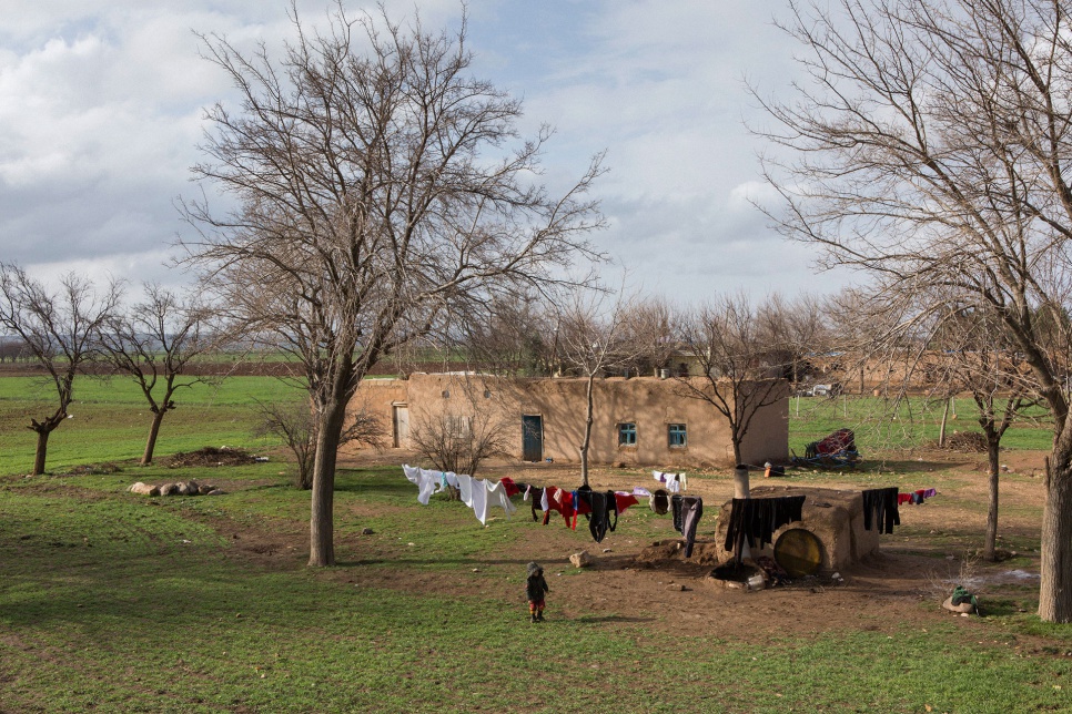 Ali, 3, plays outside the cottage where his family is living in the Turkish village of Saygin. Local residents have extended a welcoming hand.