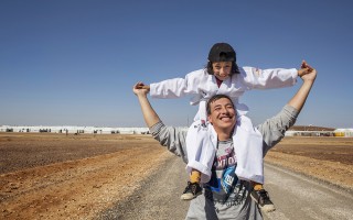 Jordan. Nine-year-old Syrian refugee, Solaf, with her brother Munaf, 21, at Azraq refugee camp