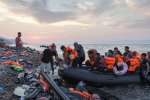At sunset a group of mostly Syrian refugees arrive on the Greek island of Lesvos after crossing the Aegean Sea from Turkey. 