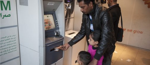 Hamidi (34) picks up his family's UNHCR monthly cash assistance at the bank, with daughter Aya (7) and youngest son Mohamad (4) in tow. Hamidi, his wife Noufa (37) and their six children fled their home in the countryside near Aleppo, Syria in 2013, fearing for their lives. Hamidi comes from a poor family and the conflict in his homeland has only left his family more destitute and vulnerable. Today, they live in a tiny shelter near downtown Amman, surviving only through the support they receive from UNHCR and partners  a far cry from their home in Syria, which had a beautiful garden with a pomegranate tree, jasmine flowers and grape vines. Hamidi is one of over 137,000 Syrian refugees benefitting from a UNHCR monthly cash assistance programme in Jordan, which provides a lifeline to families who have lost everything and now struggle to survive  refugees in a foreign land. [The cash assistance] helps a lot, it covers half of my expenses. - Hamidi ; As of May 2016, Jordan hosts more than 650,000 registered Syrian refugees, of whom the vast majority live in urban areas. Years into their exile, these families have depleted their savings and are struggling to pay for the very basic life essentials, like rent, food and healthcare. UNHCR helps restore the dignity of families who have lost everything by supporting them to cover the cost of basic life essentials such as rent, food and healthcare. UNHCRs monthly assistance programme uses fraud-proof iris-scan technology to distribute cash funds through special ATM machines, without the need for a bankcard or PIN code.