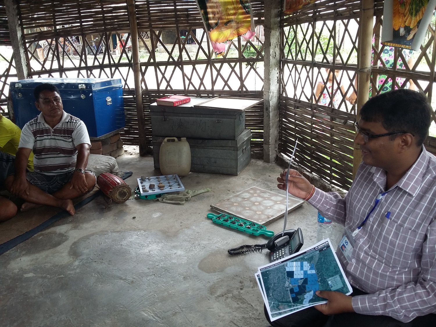 Pintu facilitates a brainstorming workshop with elderly refugees in Nepal.