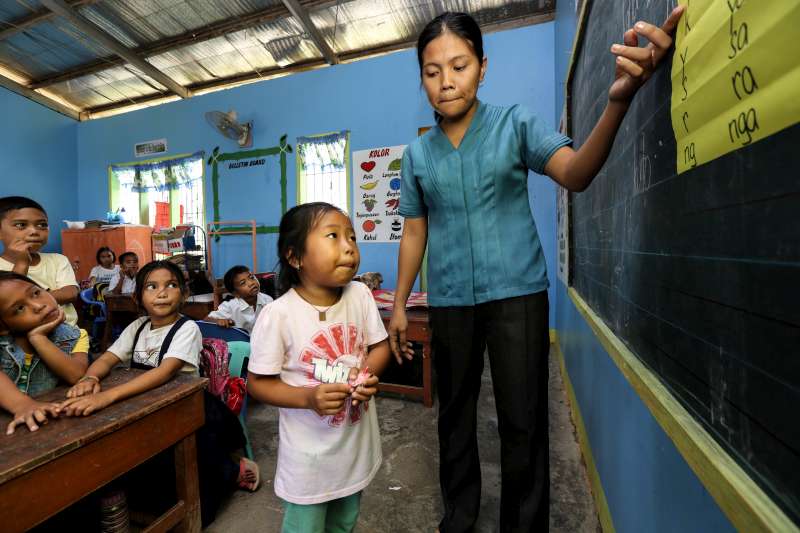  المعلمة كاثرين مايا تدير صفاً للصغار في مدرسة واقعة بالقرب من المآوي الانتقالية في نيو كاوايان. تغيّب بعض الأولاد عن المدرسة لأشهر عديدة بعد إعصار هايان.  