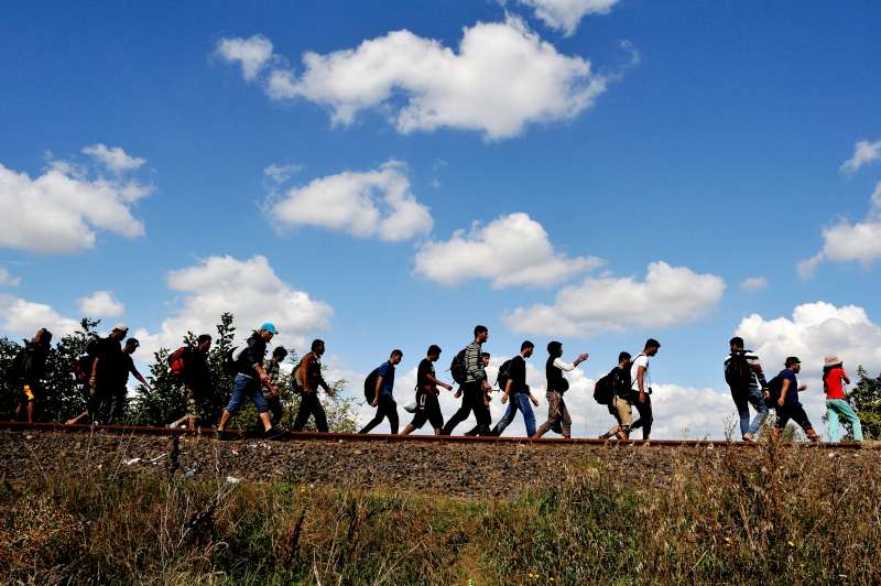 Refugees walk along an old railway line, just after crossing from Serbia into Hungary. 