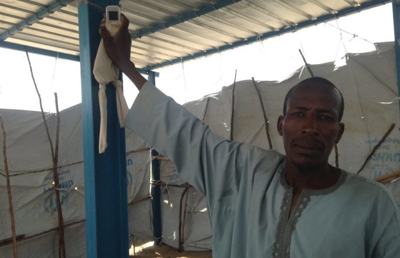 One of the community elders in Sayam Forage, demonstrating the phone and tights communication system.