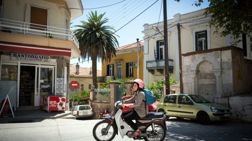 Efi Latsoudi rides her scooter from her home in Mytilene to a yoga session, run by volunteer Konstantin.