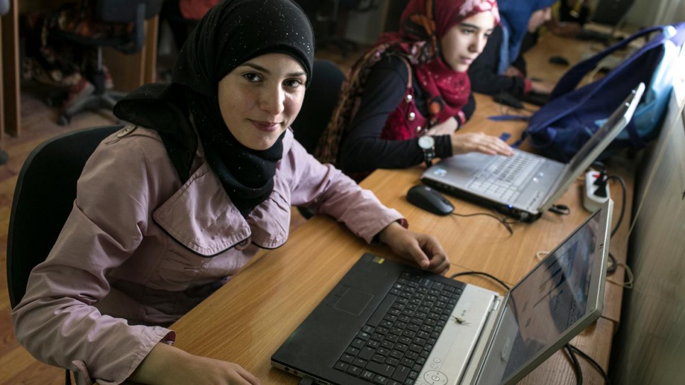 Teens attend an extracurricular computer education class at Za'atari refugee camp in Jordan in 2015. The class is taught by a Syrian computer engineer through one of UNHCR's NGO partners.