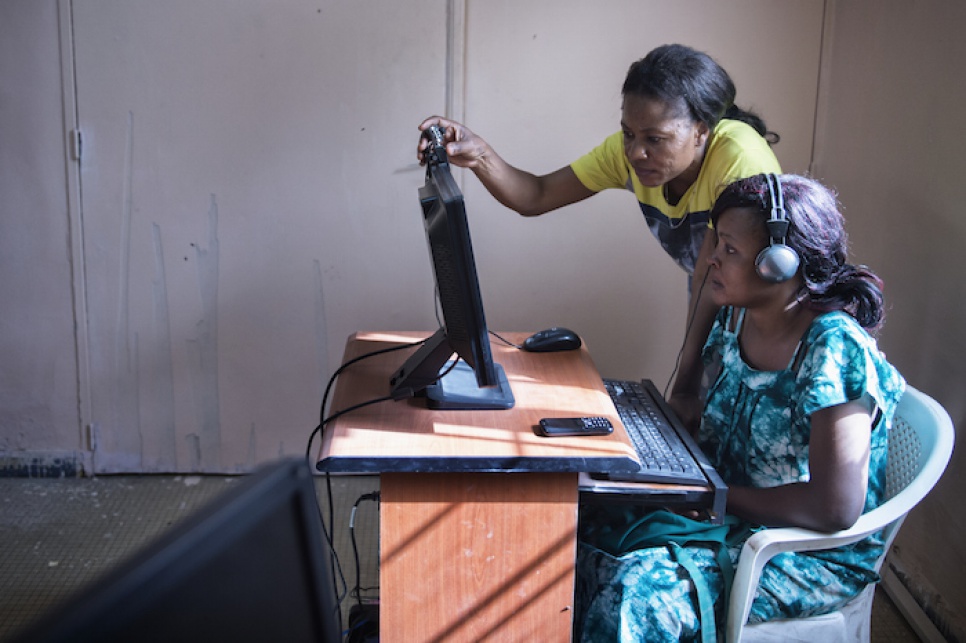 Budiaki helps a student connect with her family via the Internet at Nouakchott's Women's Centre.