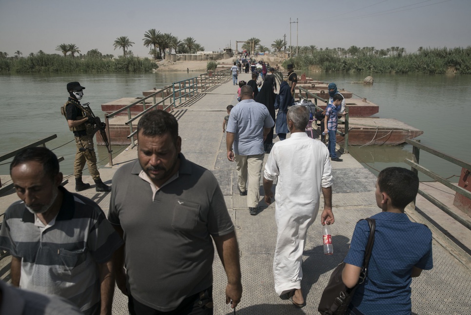 Iraqis cross the floating bridge near Bzeibiz, west of Baghdad.