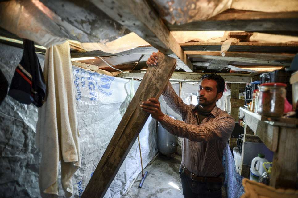 Hayel, who fled Syria with his young family, uses a wooden pole to support the kitchen roof in his makeshift shelter in Lebanon. It's so dangerous that he doesn't let the children in the kitchen.