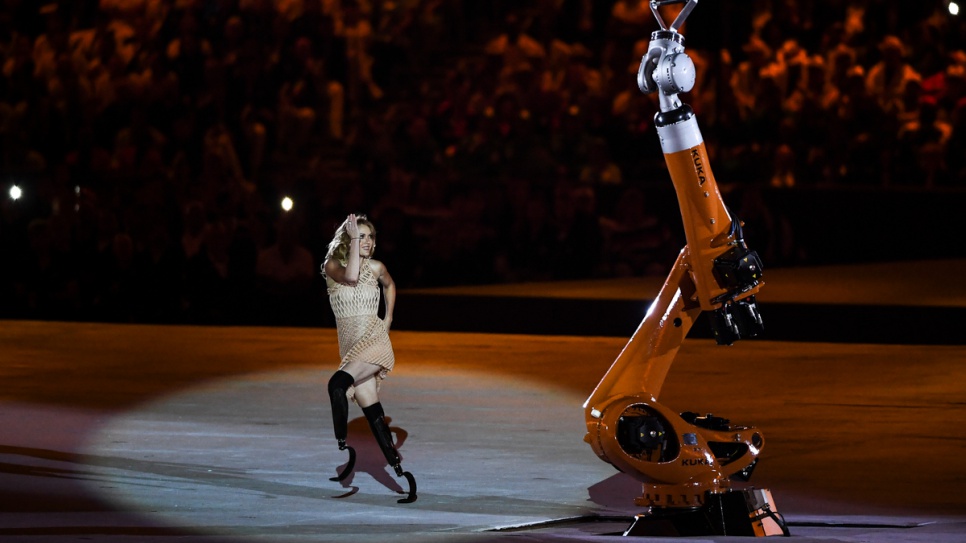 A performer with a disability dances with a robot at the Opening Ceremony of the 2016 Paralympic Games in Rio de Janeiro.