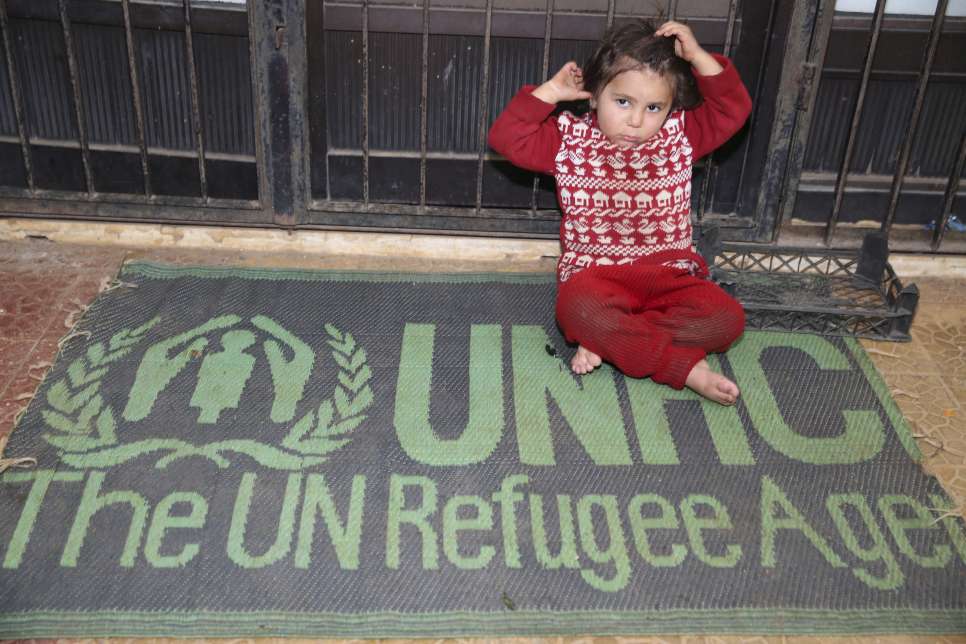 Syria / A Syrian displaced girl sitting on a UNHCR sleeping mat in this stadium which is a shelter for her and her family. Thousands of displaced families, mainly from Aleppo, are staying in makeshift shelters in Tartous that lack the basic services. The coastal city of Tartous on the Mediterranean, during the winter is usually wet with storms of heavy rain. UNHCR together with its implementing partners rushed to make these shelters ready for the rain season, through the winterization of the shelters and providing most needed core relief items including plastic sheeting, sleeping mats, blankets, mattresses, kitchen sets and hygiene kits. / UNHCR / B. Diab / November 2014
