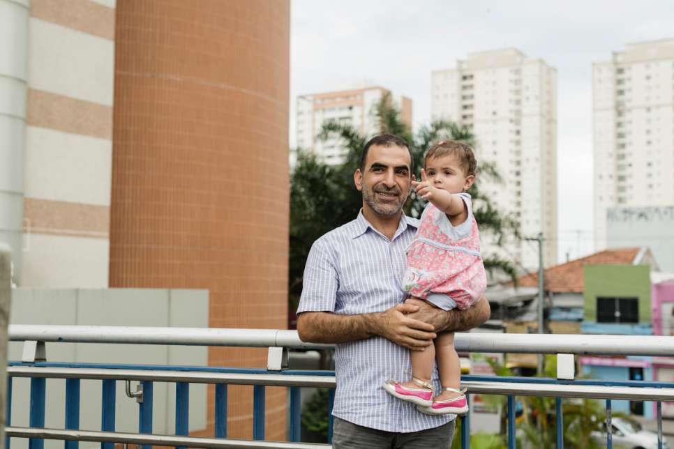 Khaled stands with one-year-old Yara during a Sunday afternoon trip to a shopping mall in the Tatuape neighborhood of São Paulo.