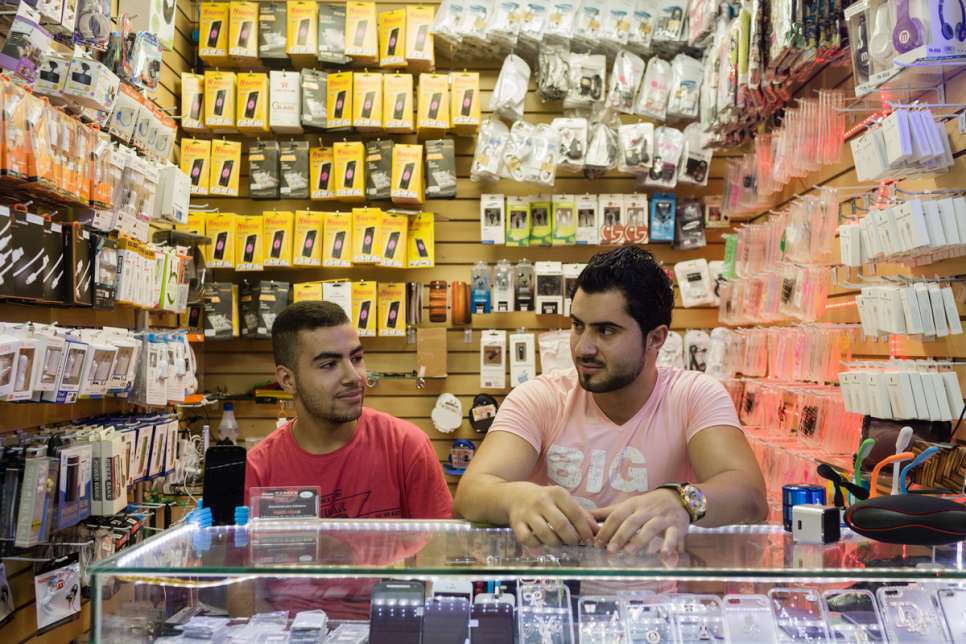 Moustafa, 16, works alongside his Lebanese boss, Hassan Salameh, 21, at a mobile phone acessories store in downtown São Paulo.