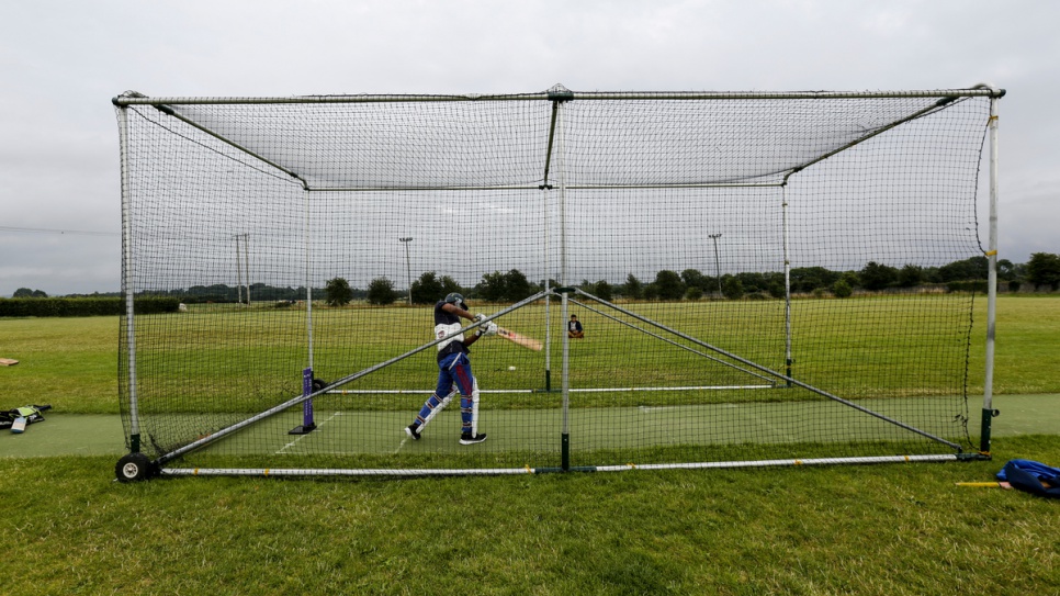 A Rohingya refugee practices batting in the nets at the Carlow Cricket Club.