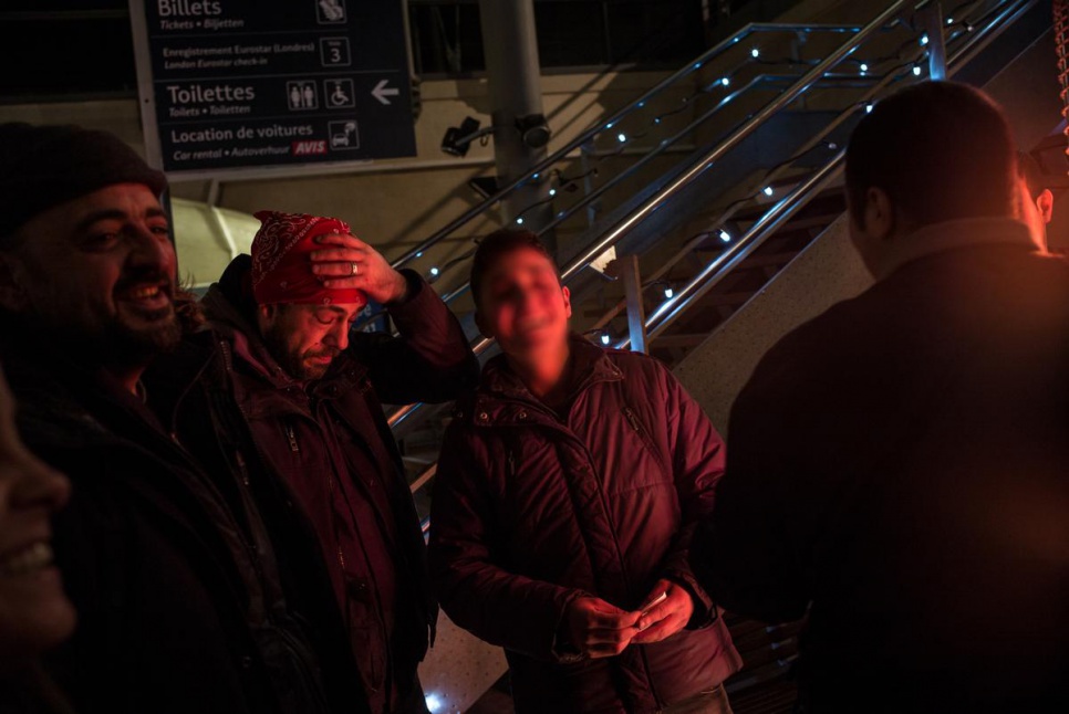 Two other Syrians staying at the camp near Calais join the four for a final farewell at the Calais train station.