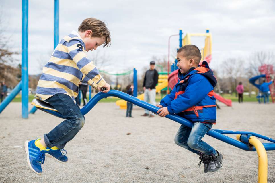 Mohammad and Sahar's son plays with a Canadian boy during an outing to the park.