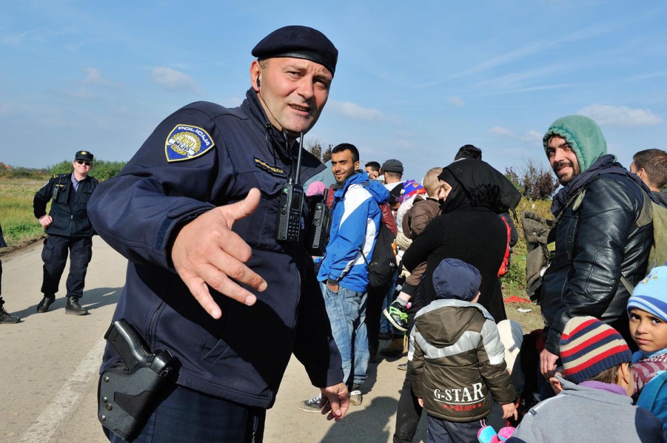 Police commander Zoran Markovic, 45, greets refugees arriving in Croatia after crossing the border from Serbia.