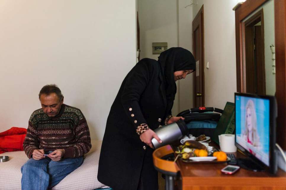 Reem Al-Hayek makes coffee in the hotel room where the family stayed in Athens while waiting for their relocation application to be approved.