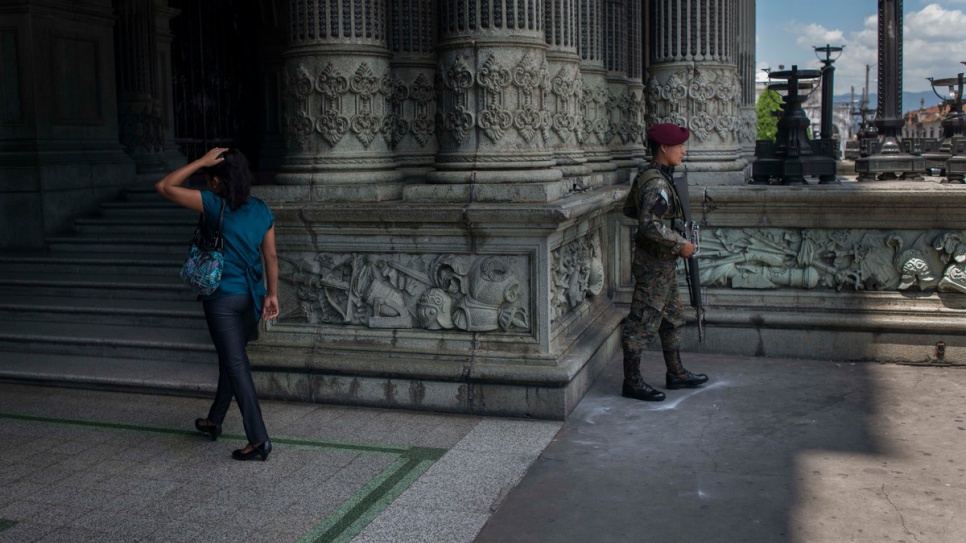 A soldier stands guard near the National Palace in downtown Guatemala City. The presence of troops, police and private security guards is widespread in the Guatemalan capital, which is one of the most dangerous cities in the world.