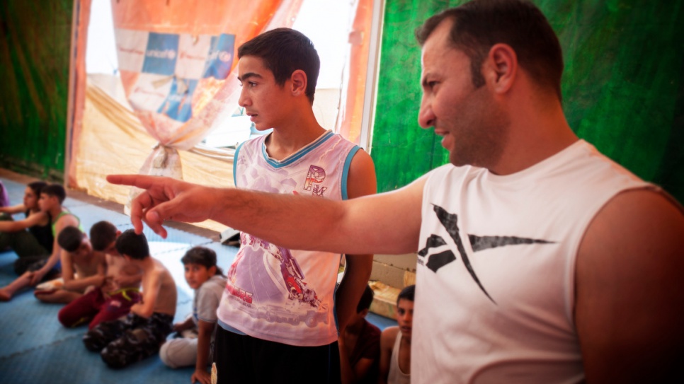 Mohammad Lakash listens to his wrestling coach, Mohammad Al Akrad, at the fitness centre at Za'atari refugee camp in Jordan.