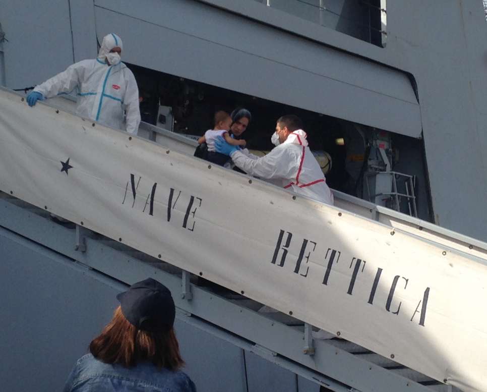 Survivors of a shipwreck off the coast of Libya disembark from an Italian Coast guard ship in  
Porto Empedocle, Sicily.