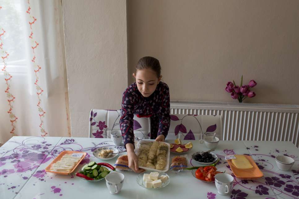 Mayas helps her mother, Darie, prepare breakfast at the apartment where they live in Istanbul. 
