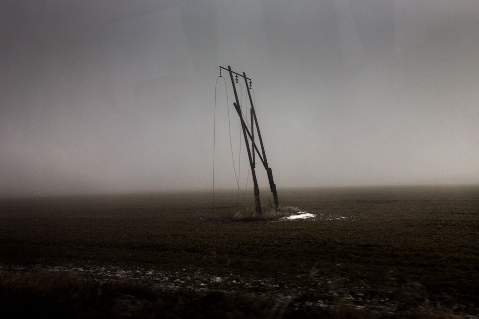 Signs of fierce fighting grow more conspicuous as a UNHCR team heads east from Donetsk towards the village of Nikishino, near Ukraine's border with Russia. Low-lying cloud cover and freezing conditions add to eeriness as the village comes into view. It is completely devastated.