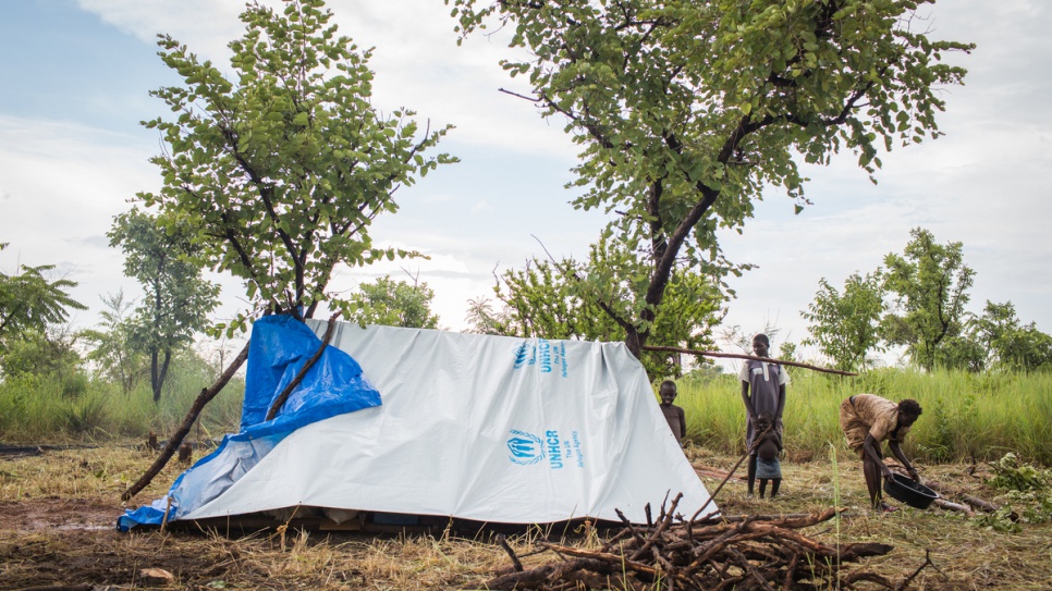 After a brief thunderstorm, Esther and her family emerge from their temporary shelter at the Pagarinya refugee settlement in northern Uganda.