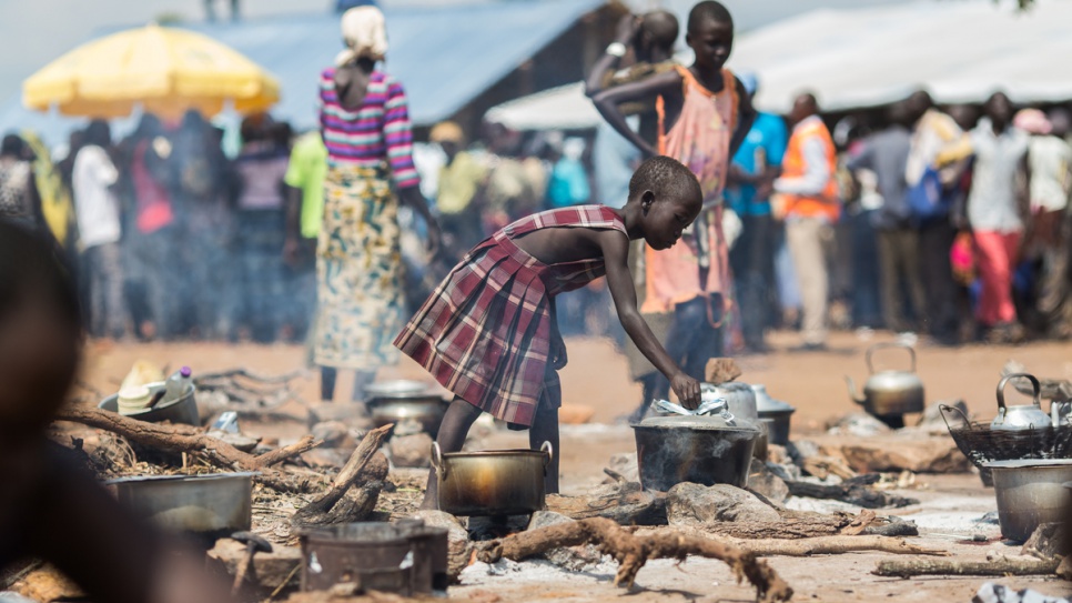 A young refugee from South Sudan cooks food at the reception centre the newly established Pagarinya 2 camp in Adjumani District, northern Uganda.