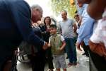 UN High Commissioner for Refugees Filippo Grandi greets a boy during a...