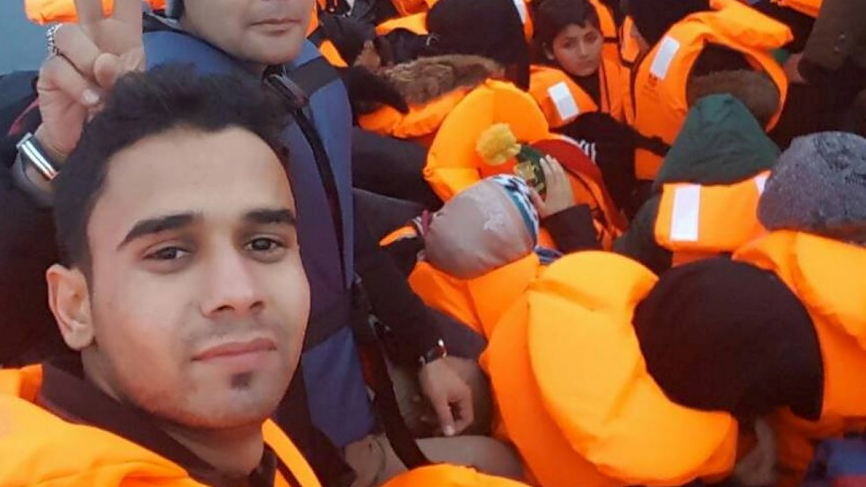 Afghan student journalist Omid Ahmadi and fellow refugees in a rubber dinghy on the sea crossing from Turkey to Greece.