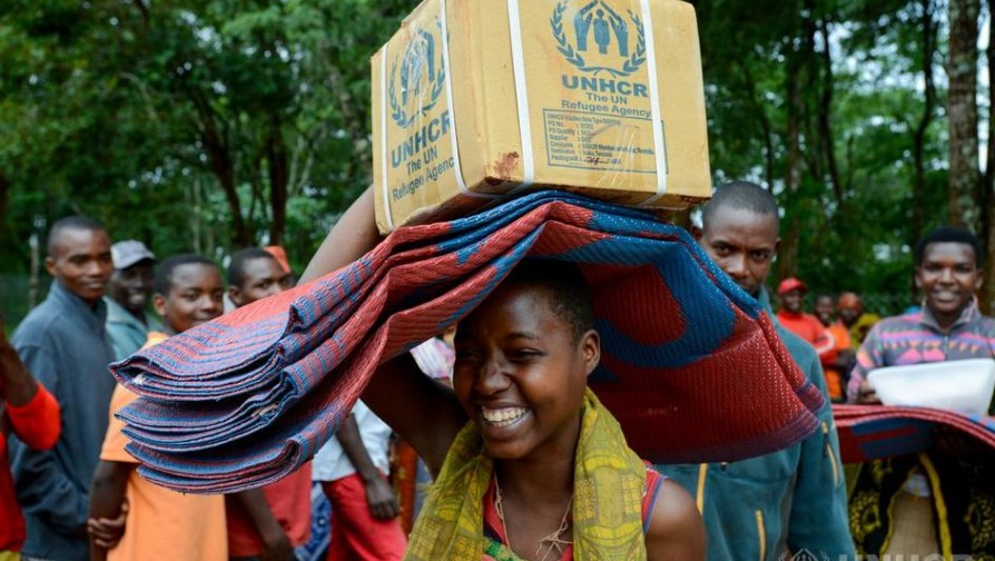 Non food items being handed out and collected by new arrivals of Burundi refugees in UNHCR Nduta refugee camp Kigoma district Tanzania ; In February, Nduta refugee camp, Kibondo Region of Tanzania was host to some 43,000 refugees from Burundi, with capacity to shelter 55,000 people. Around 200 Burundi refugees arrived at the camp every day, fleeing the violence that escalated in May 2015.   UNHCR has built emergency family shelters using wooden poles sustainably sourced from the local forests. Each family shelter has a veranda overhang to provide some outdoor shelter and storage space for firewood. Over the coming months the shelters will be upgraded using more transitional materials to provide a safer, warmer living environment.