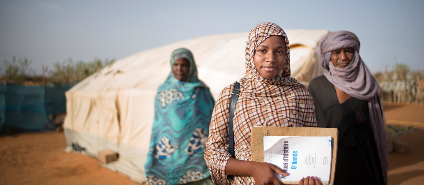 Malian refugee Tinalbarka, 16, with her parents as she leaves the family tent to attend classes at secondary school in Mbera refugee camp in Mauritania.  UNHCR/Agron Dragaj