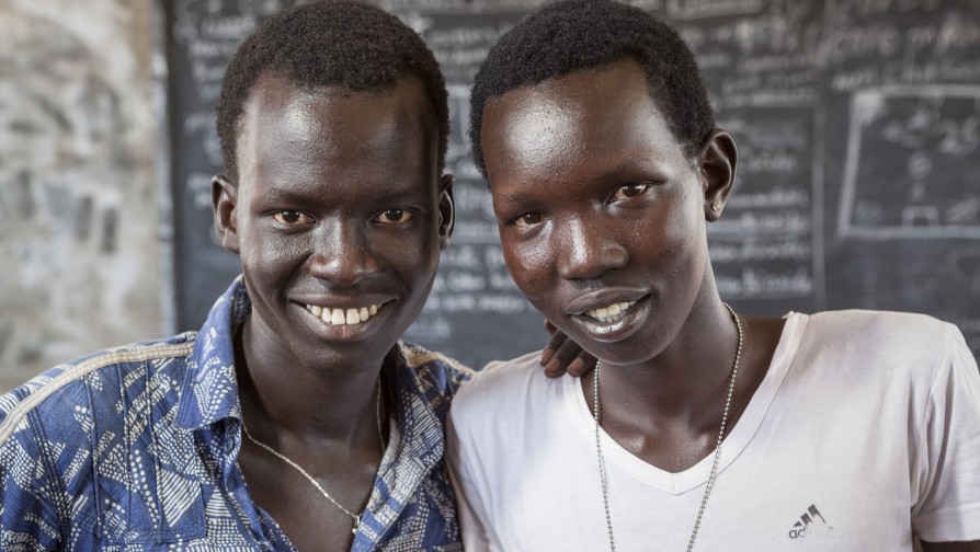 Lim Bol, Left, 21 years of age, with his cousin Gatwech Gil Thong, 17 years old, in one of the school classes in Kule refugee camp primary school. Lim cares about Gatwech as if he were his own brother. ; Lim is from South Sudan, where conflict that erupted at the end of 2013 has forced 670,000 people to flee into neighbouring countries, and made a further 1.7 million homeless inside their country. His parents are both dead, and his brother refused to leave home to flee to Ethiopia with him. Lim wants to study and become a medical doctor, but circumstances in Kule refugee camp prevent him to do so.He is alone at Gambella refugee camp, with his cousins Gatwech Gil Thong and Gahorth Kun Thong, and while his basic needs are covered, he says the interruption of his schooling is the thing that gets him down the most. While he waits to complete his secondary education, he is working as a teacher and Vice Principal at one of the camp’s over-crowded primary schools. UNHCR is helping the Ethiopian authorities provide basic education, but a lack of funding means secondary schooling stops after one year instead of four. “This really is not good for us,” says Lim. “I want to go back to my country as someone with knowledge, you know, someone with the power to serve other people.”