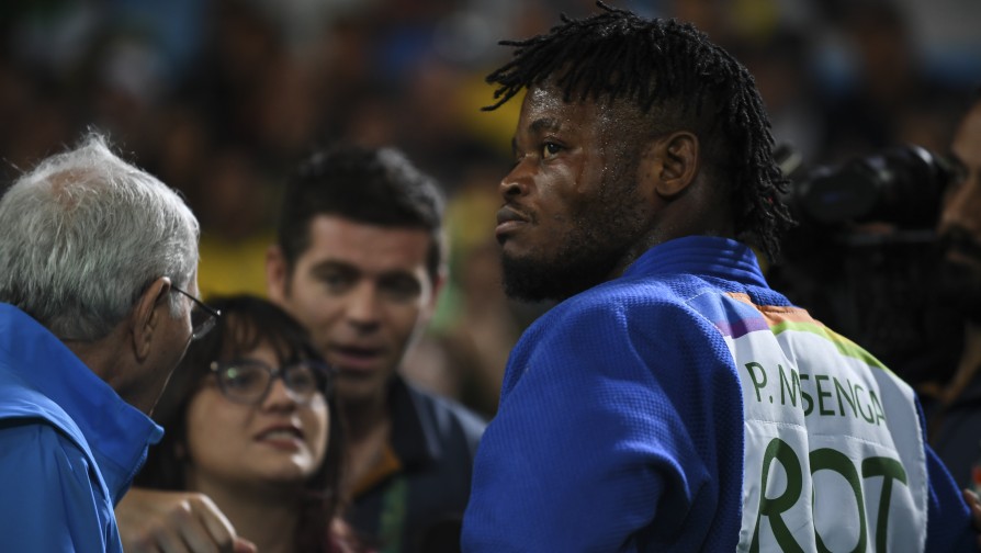 Popole Misenga absorbs the adulation of the crowd in Rio de Janeiro after his second round match against Gwak Dong-han from the Republic of Korea. ; For the first time in Olympic history the International Olympic Committee (IOC) has created a team of refugees who will compete as the Refugee Olympic Team in Rio in August 2016.  Popole Misenga was separated from his parents as a child during fighting in the Democratic Republic of the Congo. He lived in a home for displaced children in Kinshasa and trained in judo. He now lives in Brazil where he sought asylum after being abandoned by his coach during an international competition. He shares a tiny apartment in a favela in Rio with his Brazilian partner, Fabiana, and their four children where the whole family sleeps in one bedroom. Popole trains with coach Flavio Canto, an Olympic bronze medallist in judo and earned a place on the Refugee Olympic Team for Rio 2016.