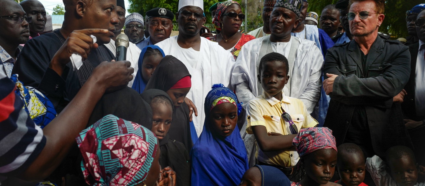 Bono, the lead singer of U2 and cofounder of international campaigning and advocacy group The ONE Campaign, visits displaced families at a settlement in Maiduguri, Nigeria.  © Roopa Gogineni @ ONE