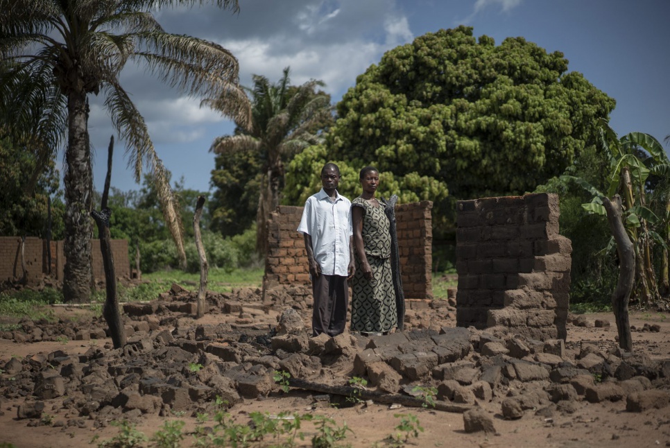 Pastor Mokoyo Jean and his wife, Wilambwe Antoinette, stand amid the ruins of their home in Kasonsa village, where hundreds of houses were burned in July during intercommunal clashes.