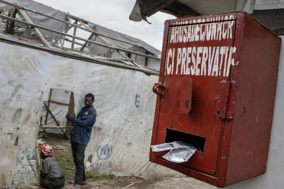 A box dispensing free condoms hangs from the side of a shelter in Kilimani IDP camp, Masisi.