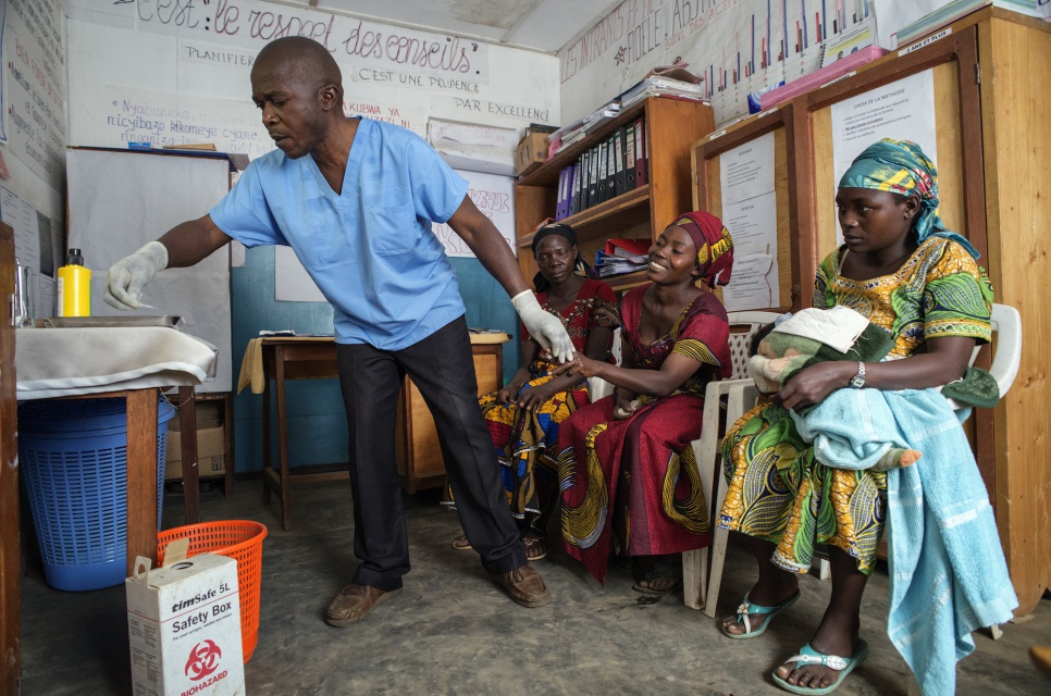 Dr. Kalibongo Raymond draws blood from a Congolese woman's finger during a screening for sexually transmitted diseases at the health centre in Kitsule, North Kivu.