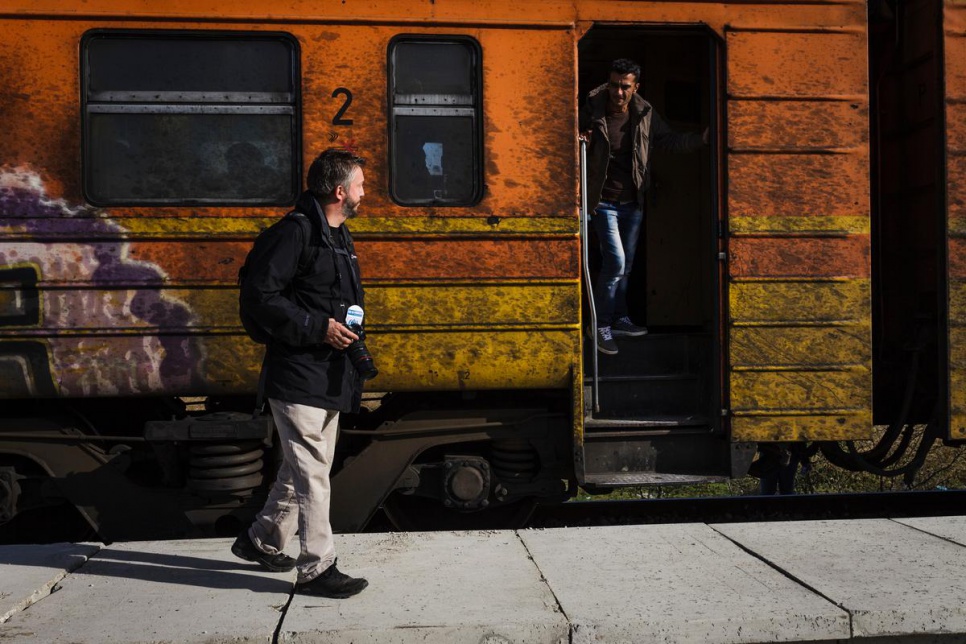 Giles Duley walks past a train refugees use to travel through the Former Yugoslav Republic of Macedonia.
