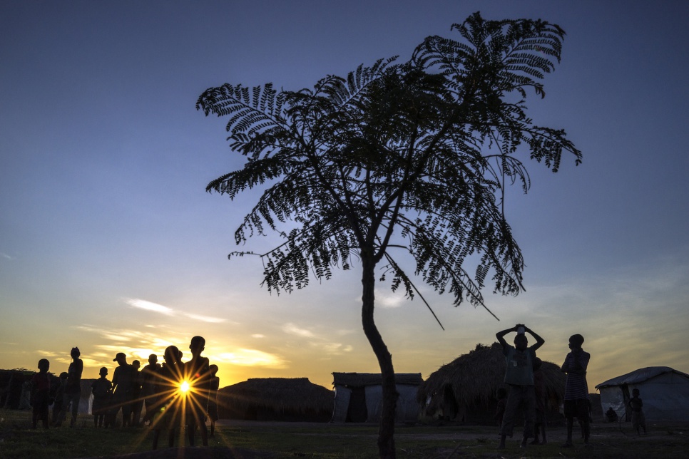 In Lukwangulo, the sun sets behind a group of people displaced from South Kivu province.