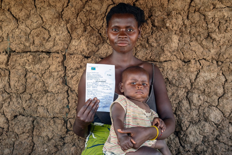 Step 5: Provide Children with Birth Certificates. Honorine Ntompa holds her six-month-old daughter, Ngongo Honorine, and her new birth certificate in Kabembe, DRC.