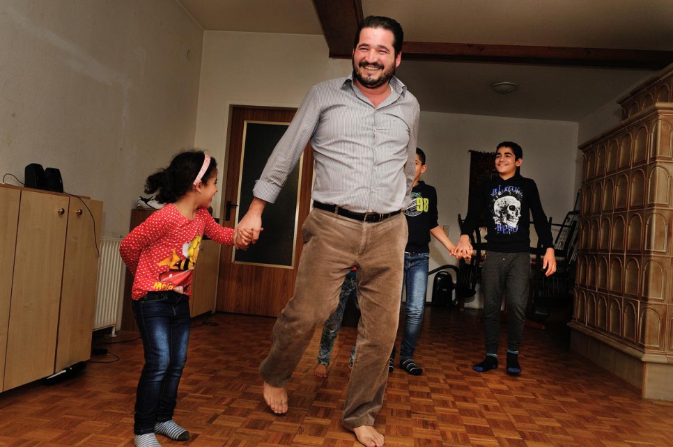 Ameen dances with some of his children in the hall of their new home in Gänserndorf.